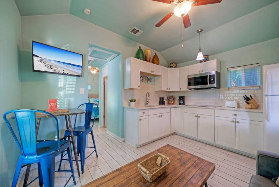 Bright, coastal-inspired kitchen and living space with vibrant décor and fully equipped amenities. (Casa San Miguel)