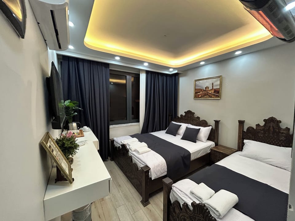 Deluxe Triple Room, Patio | Desk, laptop workspace, free WiFi