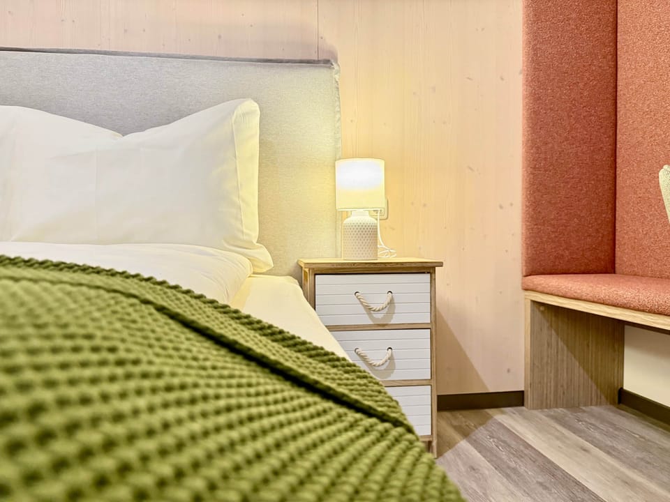 Double bed with bedside table and wardrobe