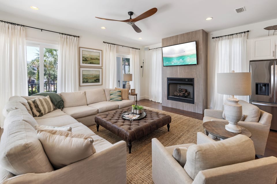 Sink into plush sectional seating while enjoying your favorite shows on the wall-mounted TV above the cozy fireplace in this thoughtfully designed living space.