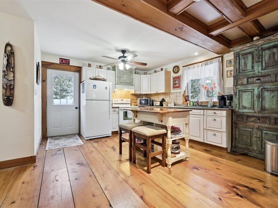 Bright, fully equipped kitchen with rustic charm, open to the dining area for easy entertaining.