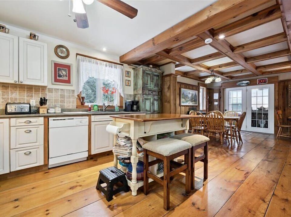 Open-concept kitchen and dining area, blending classic cottage character with modern comfort.