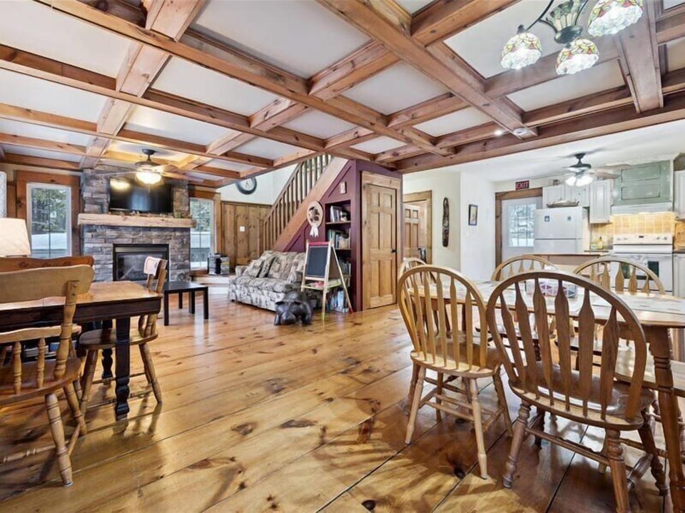 Warm and inviting great room with pine floors, propane fireplace, and plenty of space to gather.