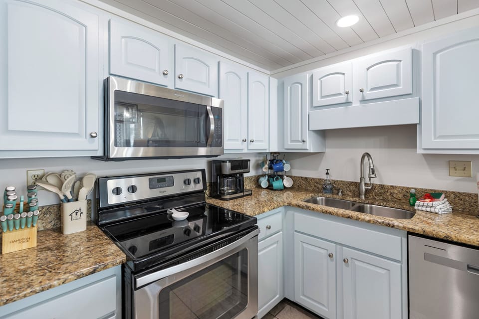 Your fully equipped kitchen features granite countertops, stainless appliances, and ample cabinet space for preparing delicious meals during your stay.