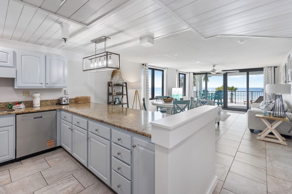 Your stylish kitchen flows seamlessly into the living space, where you'll cook with stunning ocean views through floor-to-ceiling windows.