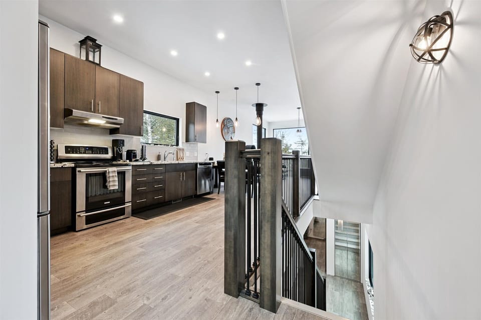 A sleek, modern kitchen with stainless appliances, generous prep space, and an open layout that keeps you connected to the rest of the home.