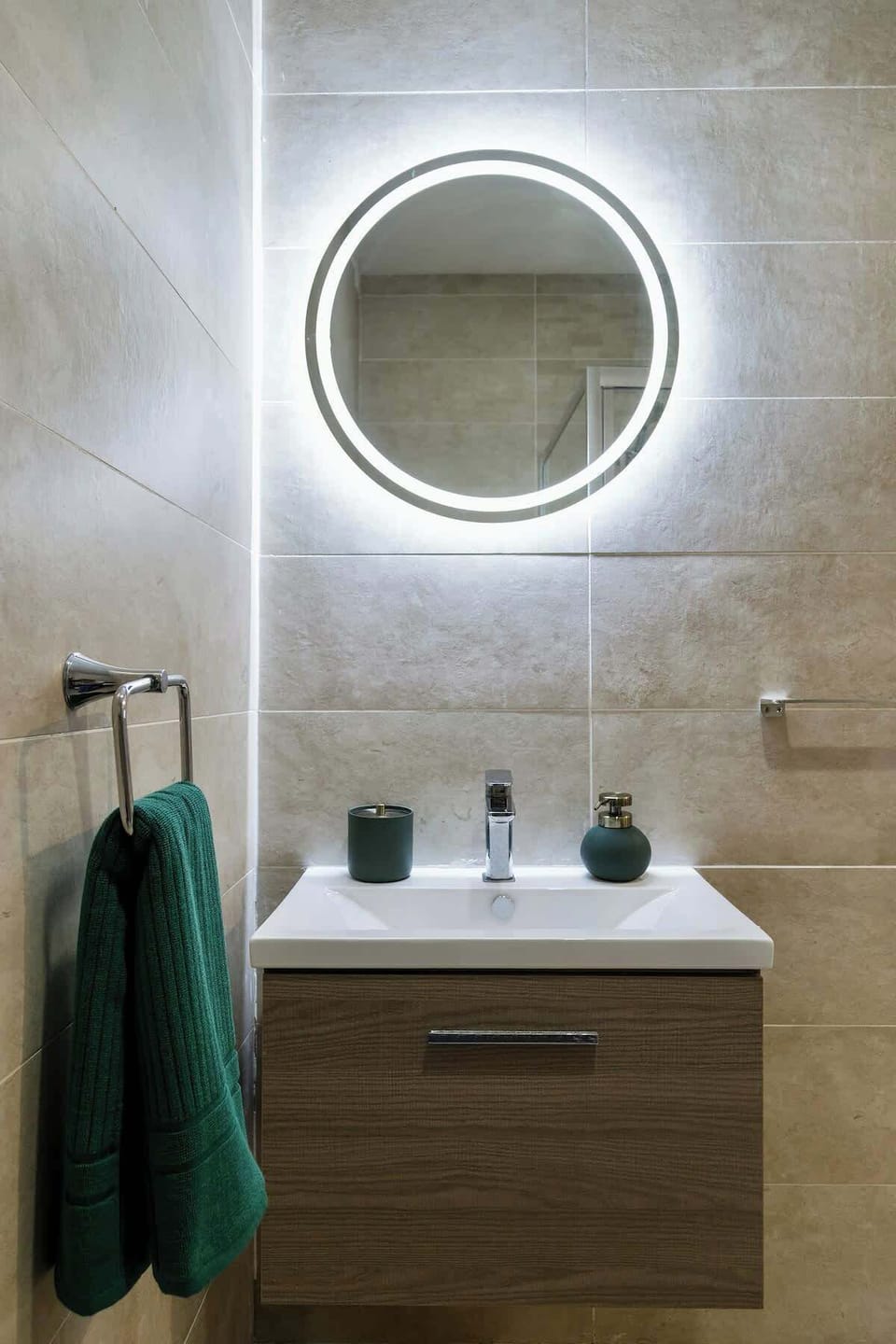 Contemporary ensuite bathroom with an illuminated mirror, walk-in shower, and essentials for your stay.