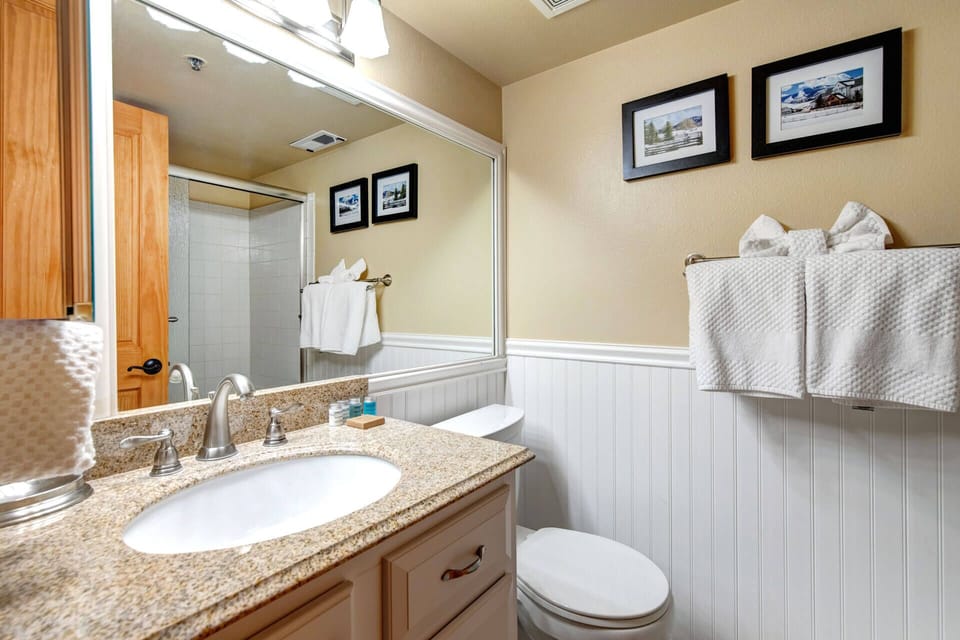 Refresh in your private bathroom with fresh towels, a granite vanity, and a well-lit space that feels clean and welcoming after a day of exploring.