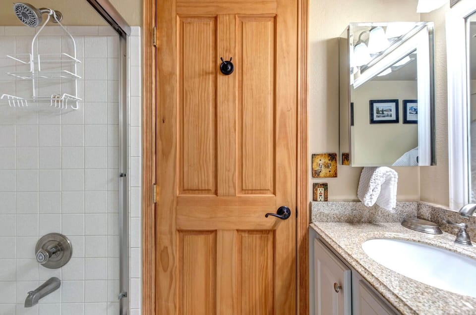 Your private bathroom offers a walk-in shower, granite countertops, and fresh towels—everything you need to refresh after a day of exploring.