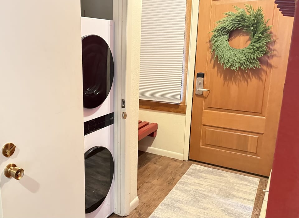 In-unit laundry with stacked washer and dryer.
