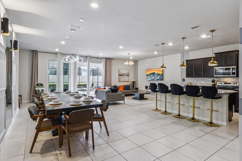 Large dining table plus bar seating ensures everyone can enjoy meals together.