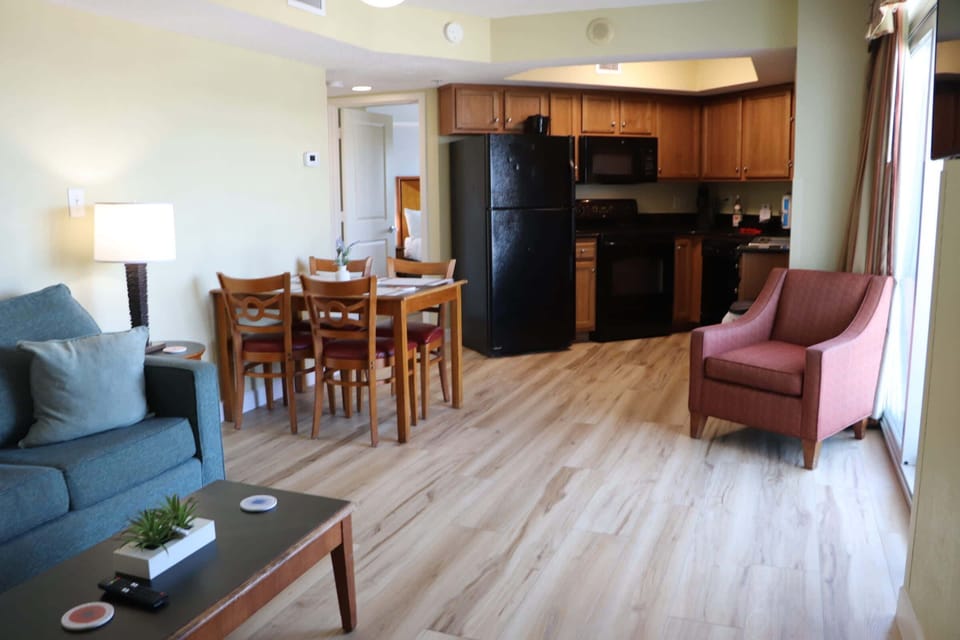 Bright and inviting living space with an open layout, comfortable seating, dining area, and a fully equipped kitchen — perfect for relaxing after a day at the beach in Myrtle Beach.