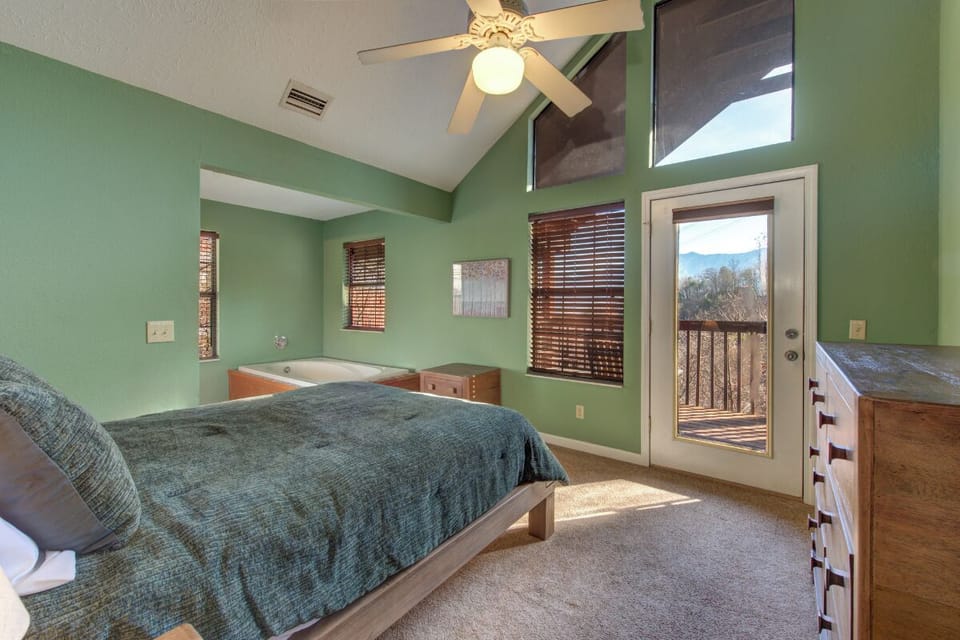 Unwind in your serene bedroom with vaulted ceilings, private hot tub, and stunning mountain views from your own balcony.