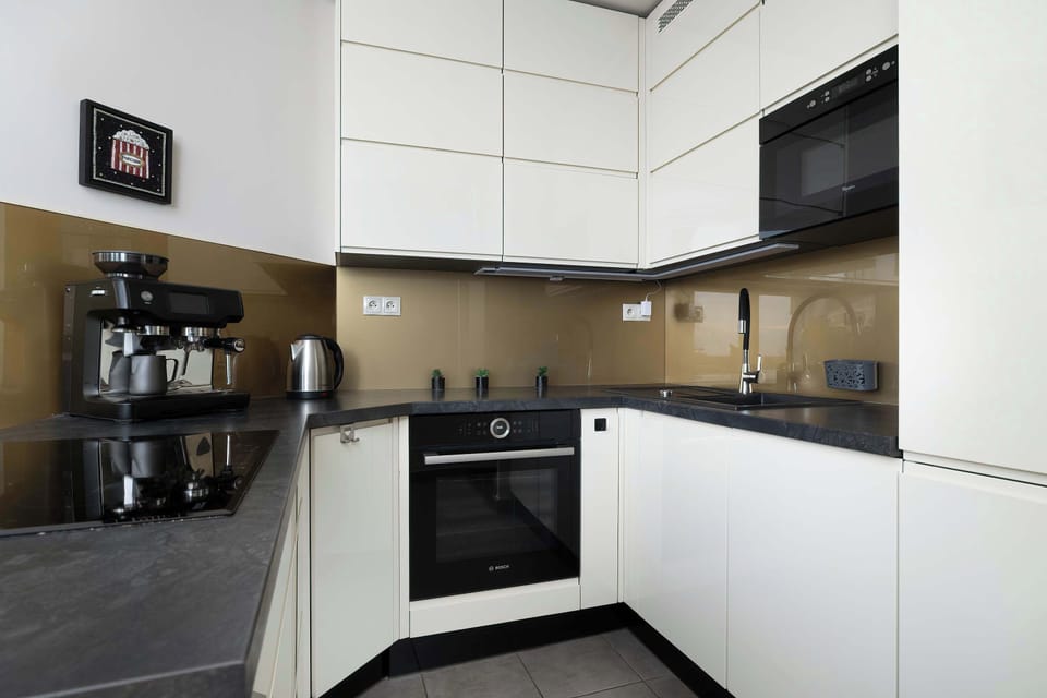 The sleek design of the kitchenette blending seamlessly with the living area.
