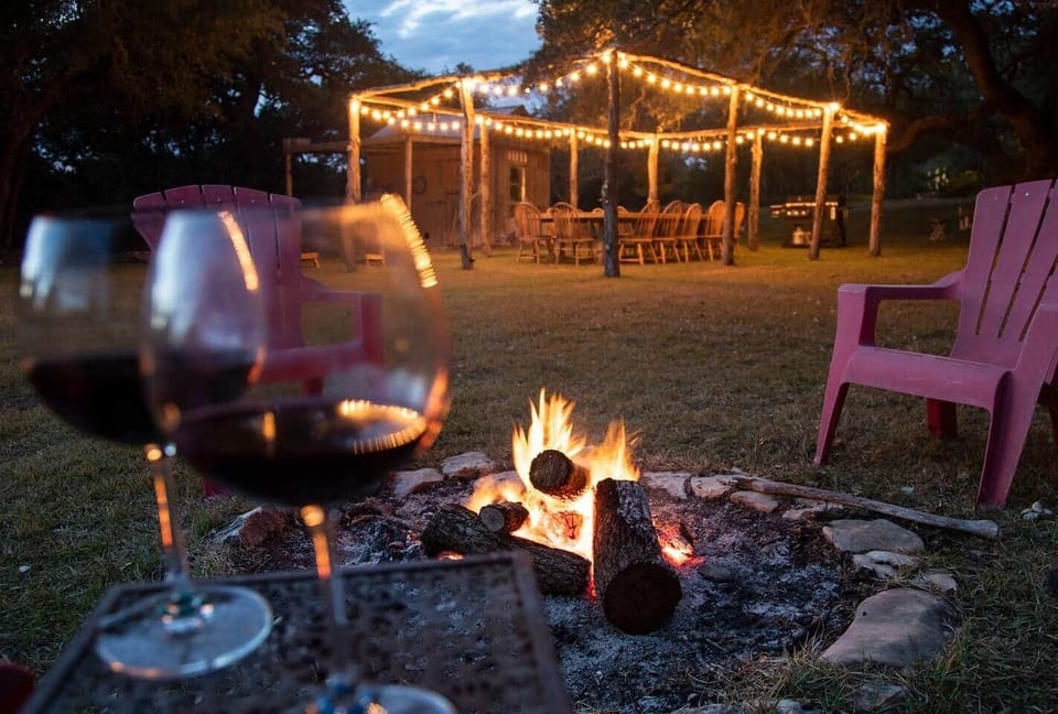 Firepit in front of outside dining table that can seat up to 16.