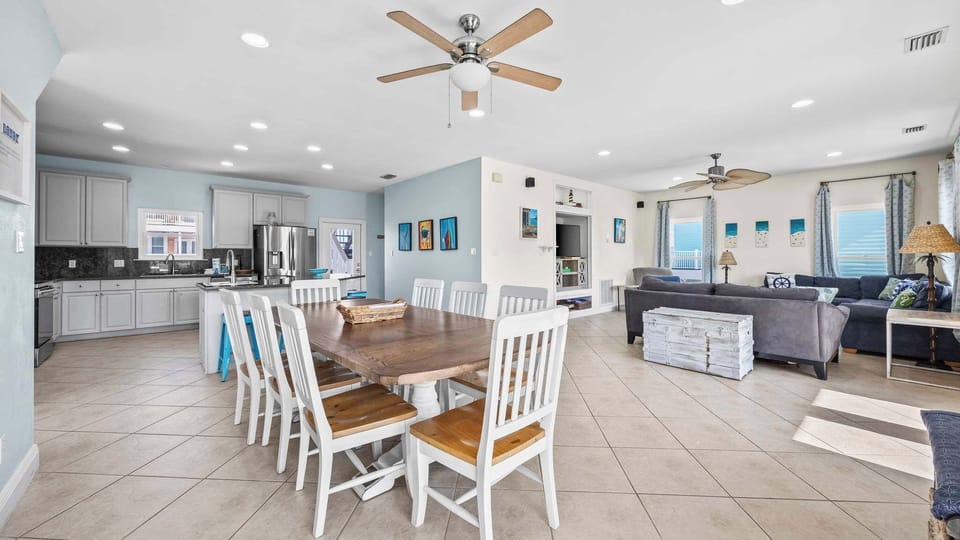 Open-concept design with natural light across kitchen, dining, and living.