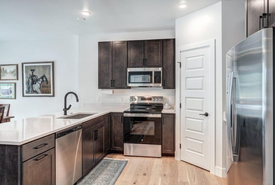 An inviting kitchen area combined with elegant finishes makes meal preparation a delightful experience in this cozy mountain condo.