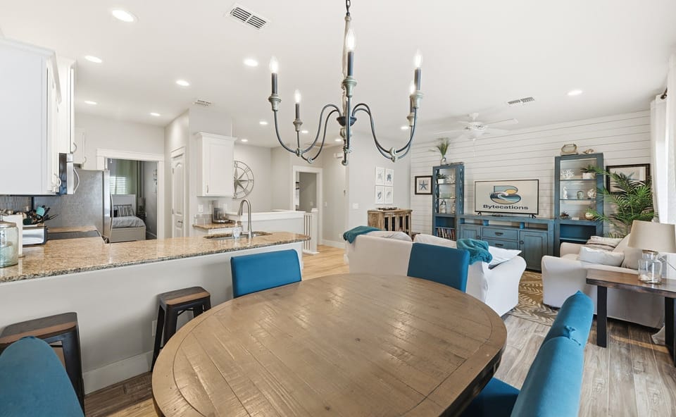 Bright open-concept living with coastal decor and granite kitchen