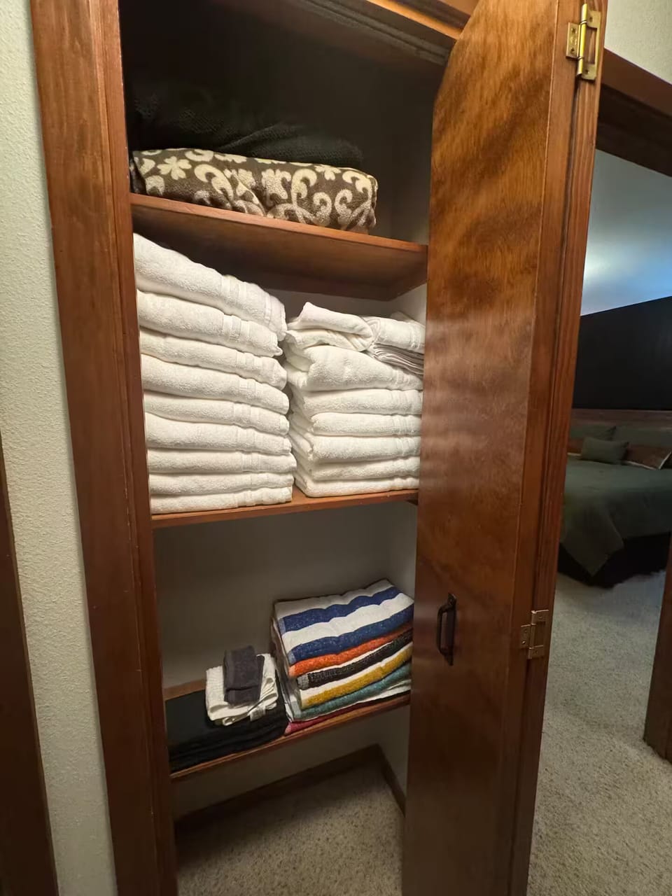 Closet with pool towels and bath towels and extra blankets