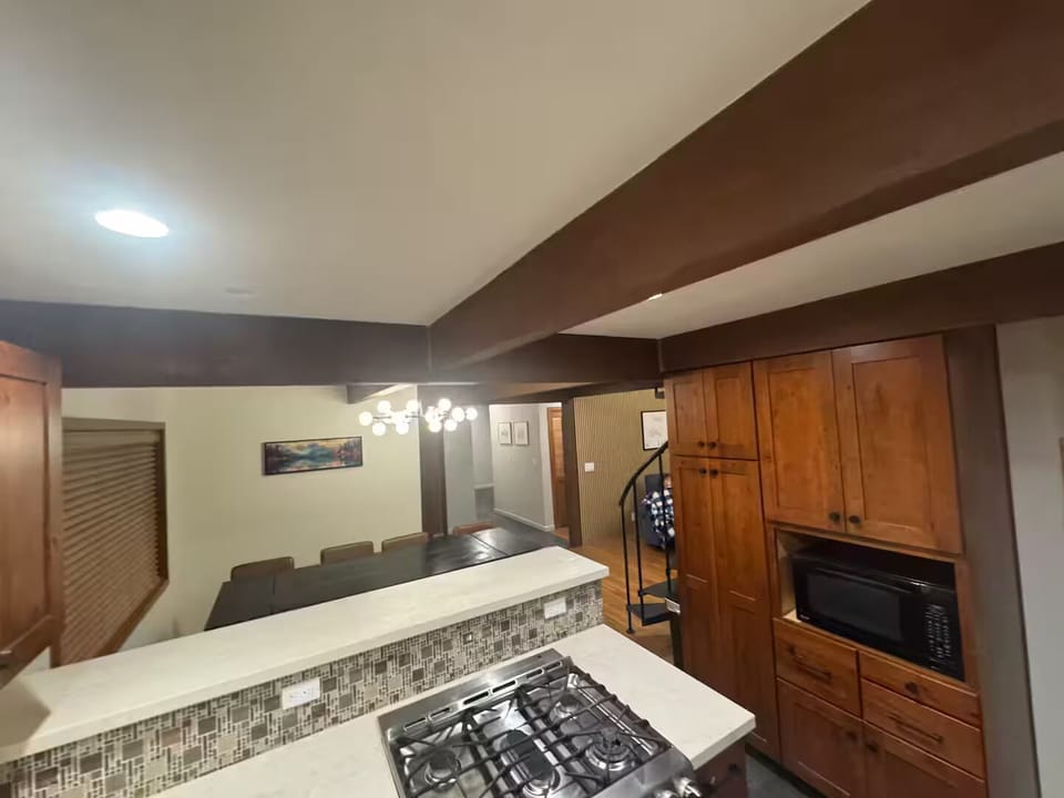 Gas cooktop and pantry for your food next to the microwave