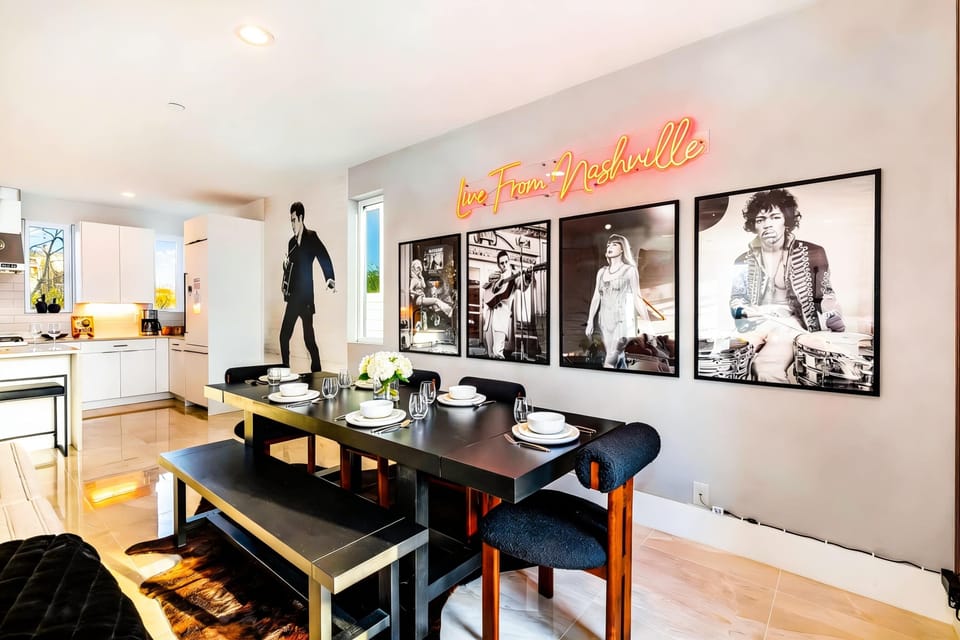 The dining table is where your crew gathers before heading out or rehashing the night. Elvis watches from the wall while you plan the next move. Book your stay with Misfit Homes to make it real