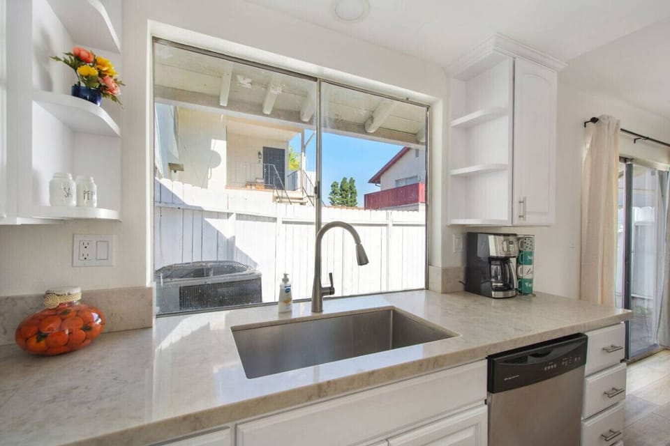 Kitchen sink area with direct access to the private patio.