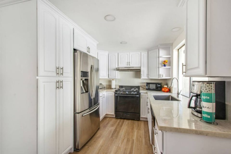 Fully stocked kitchen with modern appliances and ample counter space.