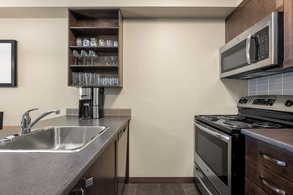 Full kitchen with a drip coffee maker, ground coffee, tea, sugar, and basic condiments (ketchup, mustard & relish.)