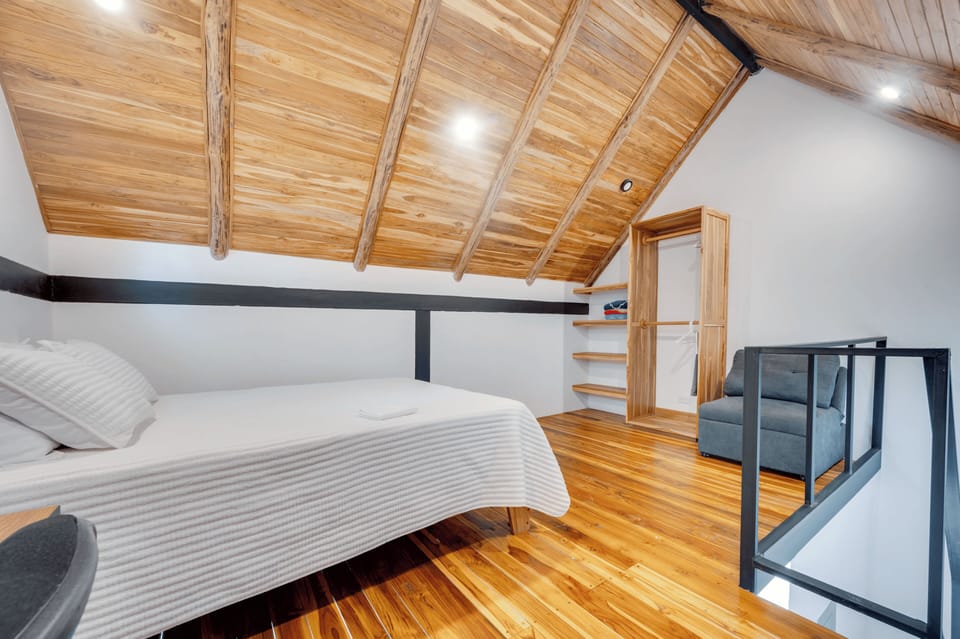 Queen-size bed and a small single pull-out couch. Wardrobe and beach towels