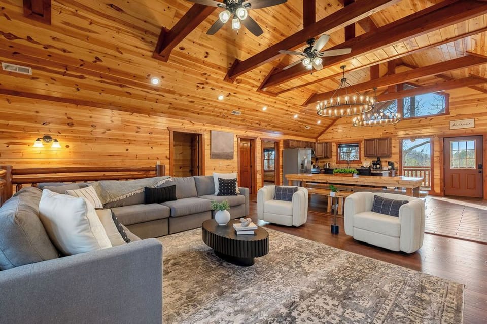 Newly remodeled living room with high ceilings, a view, and large couch. 