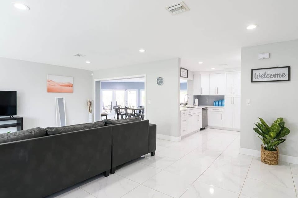"Good times and great company! ✨ Our spacious living room features a large sectional and 4K TV, perfect for group movie nights in this modern vacation rental."