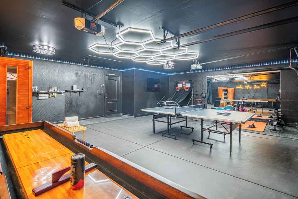 Space with ping pong, basketball toss, fitness gear, and lounge lighting