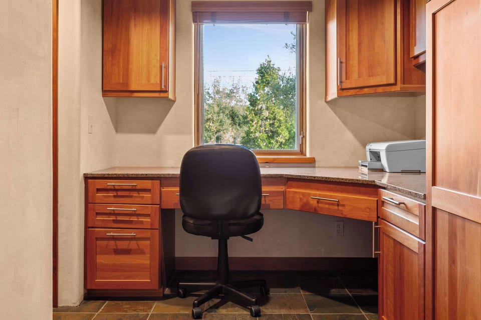 The ultimate work-from-anywhere retreat, featuring a built-in desk designed to capture the natural light and the stunning vistas of the property.