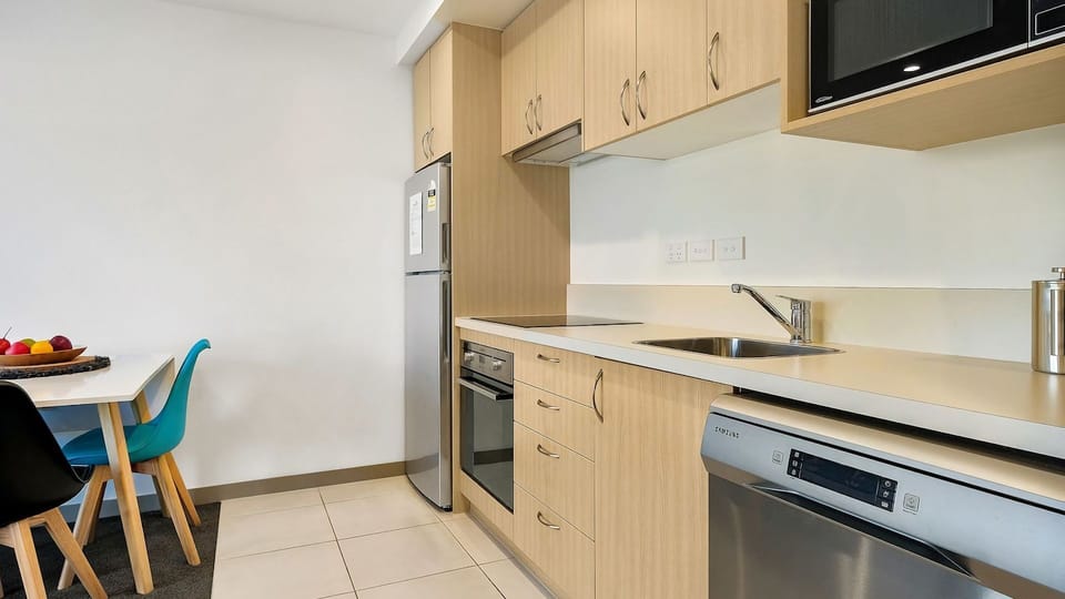Kitchen with everything you need including full size fridge, oven and stovetop, microwave and dishwasher. 
