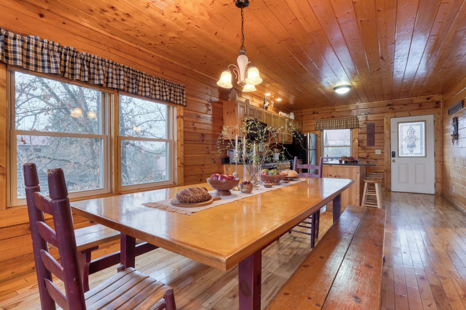 Dining area with a large wooden table and ample natural light.