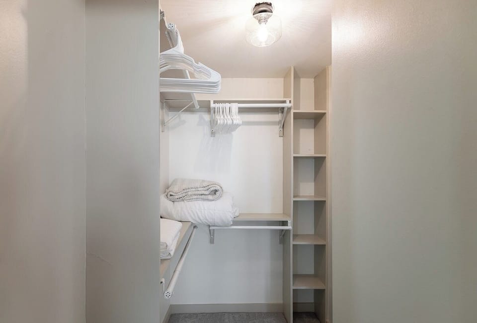 Spacious walk-in closet with ample shelving and hanging space in the primary upstairs bedroom, making long-term or extended stays comfortable and organized.