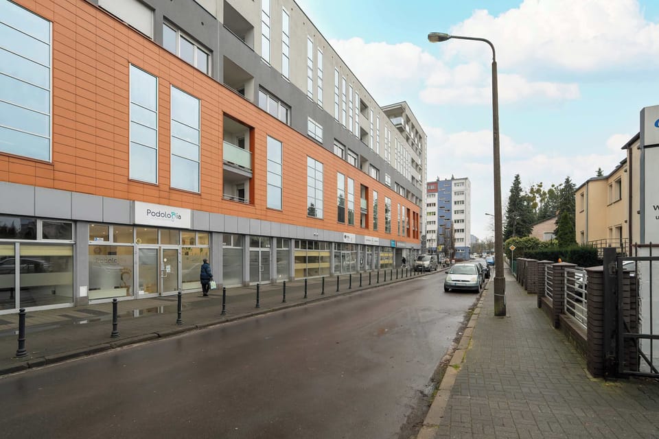 Street-side view of the property showing modern façades, tidy surroundings, and a quiet neighbourhood atmosphere.
