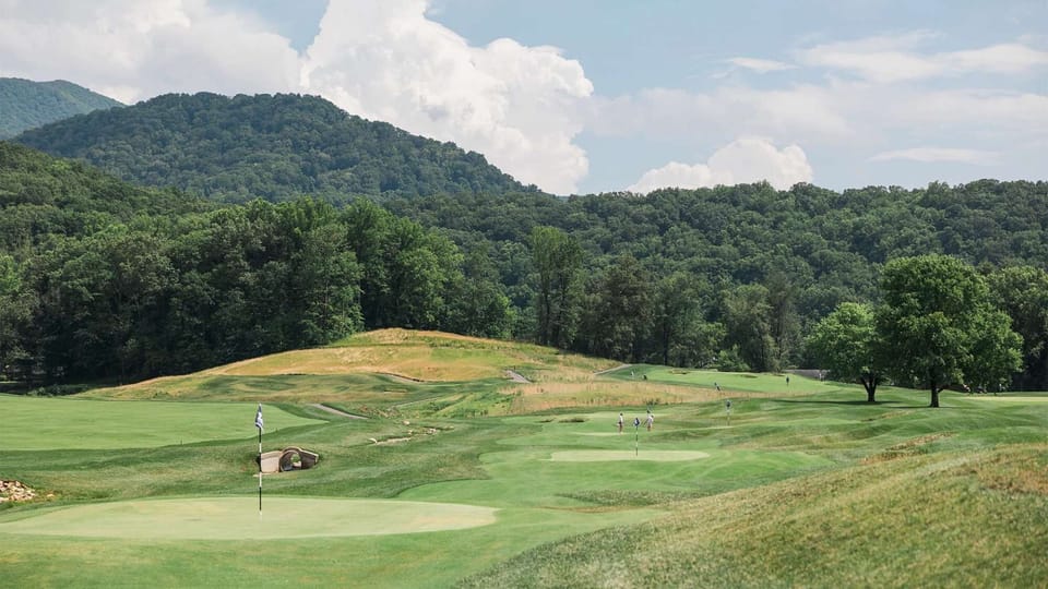 Flagged greens surrounded by hills and natural fairways