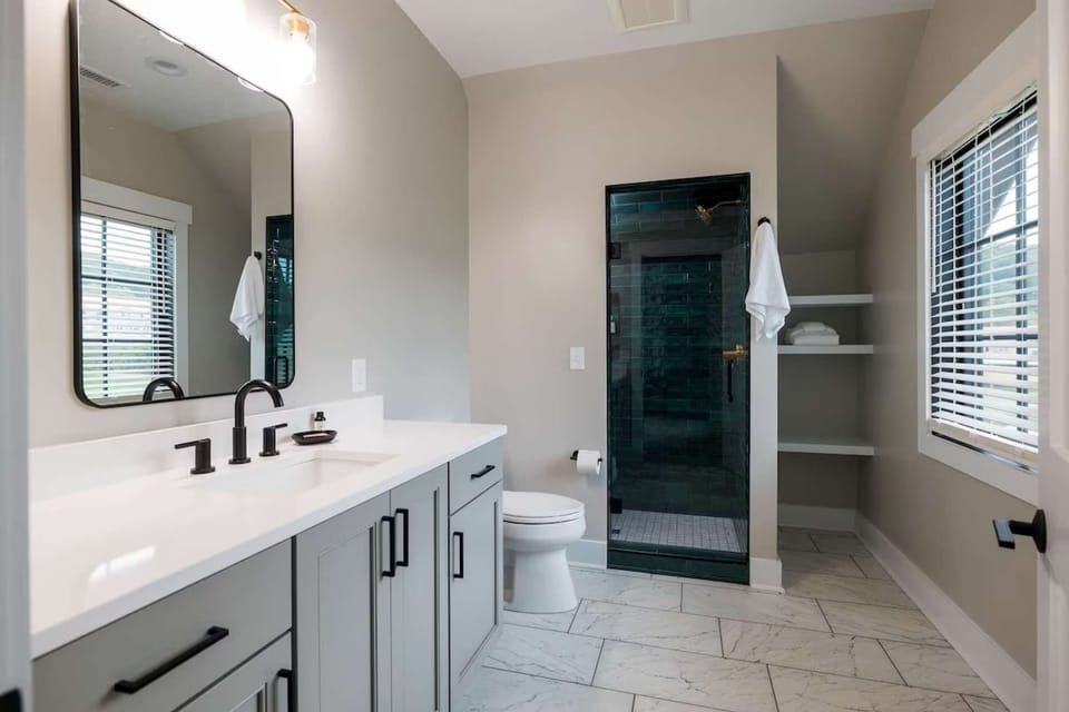 Bathroom with double vanity and walk-in glass shower