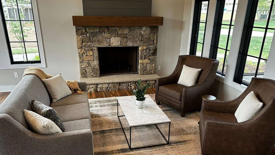 Warm seating area with fireplace and comfy chairs