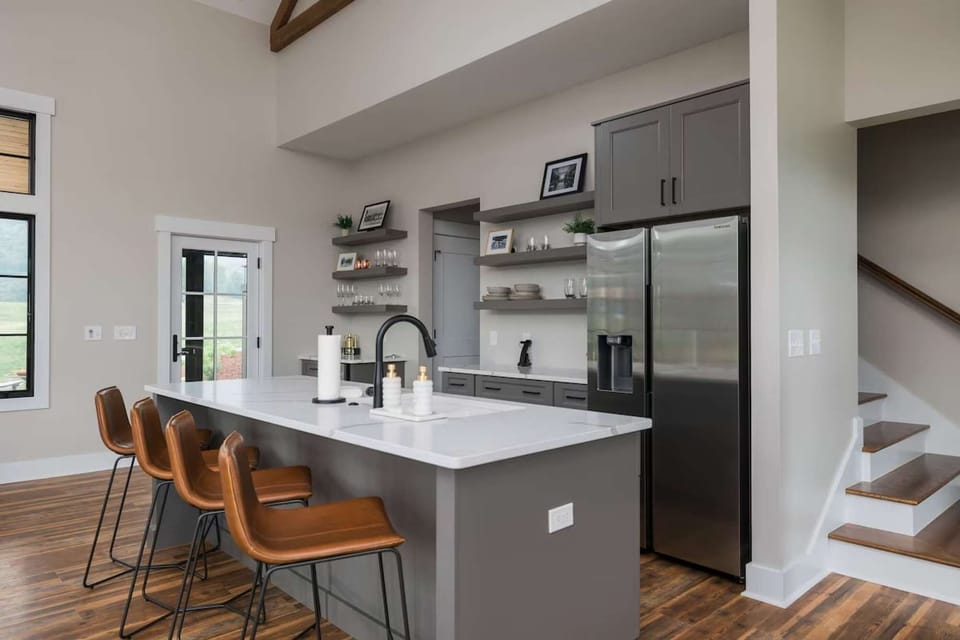 Stylish kitchen with island seating and stainless fridge