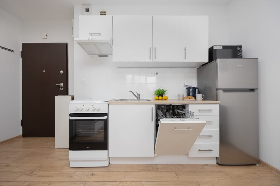 The sleek design of the kitchenette blending seamlessly with the living area.