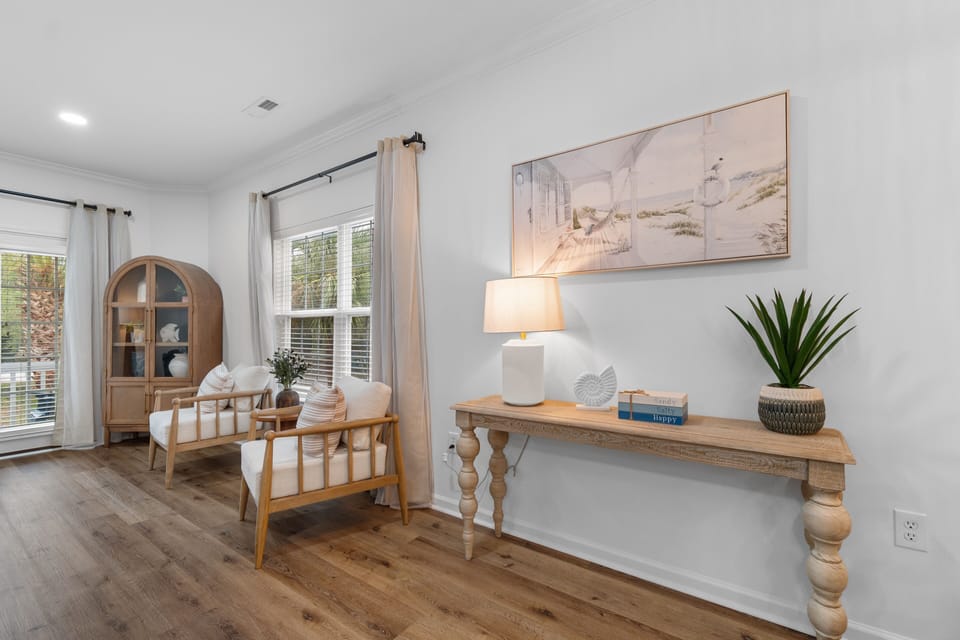 Relax in your bright, airy living space with coastal-inspired decor and natural light streaming through beautiful windows.