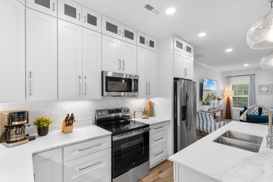 Your pristine white kitchen sparkles with stainless appliances, and endless cabinet space for your culinary adventures.