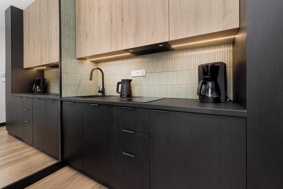 The sleek design of the kitchenette blending seamlessly with the living area.