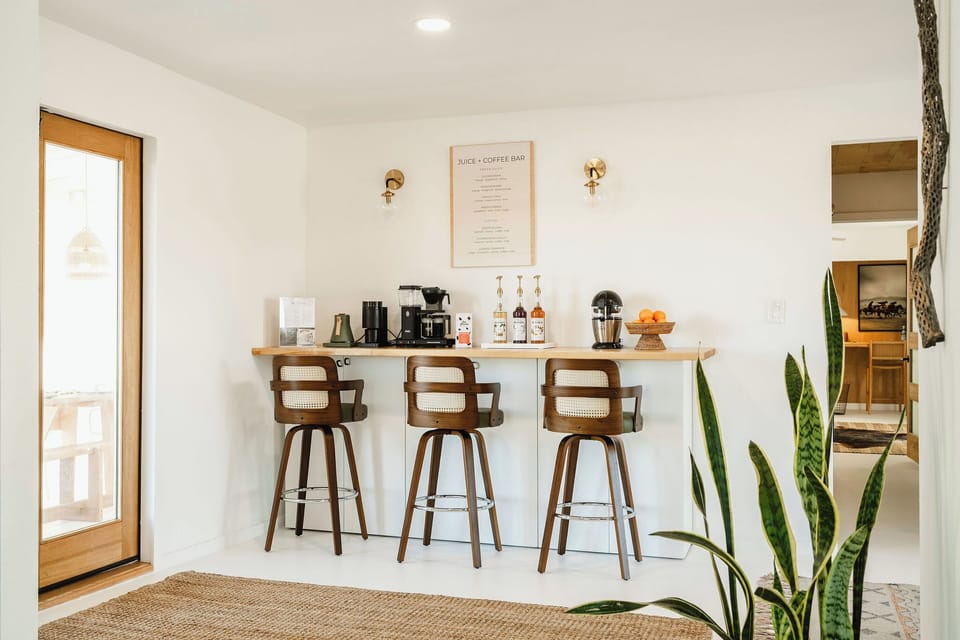 Sunlit coffee & juice bar with seating for three—perfect for slow desert mornings