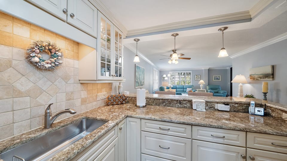 Your fully equipped kitchen features granite countertops and modern appliances, with an open design that flows seamlessly into your comfortable living area.