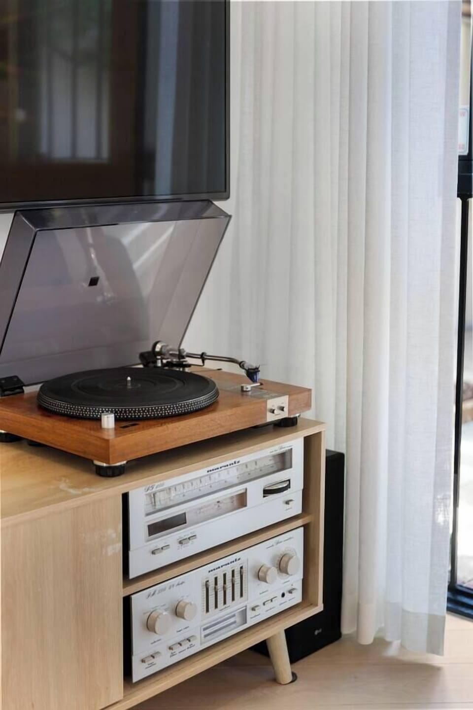The vintage turntable adds a nostalgic touch, offering an easy way to unwind with music.