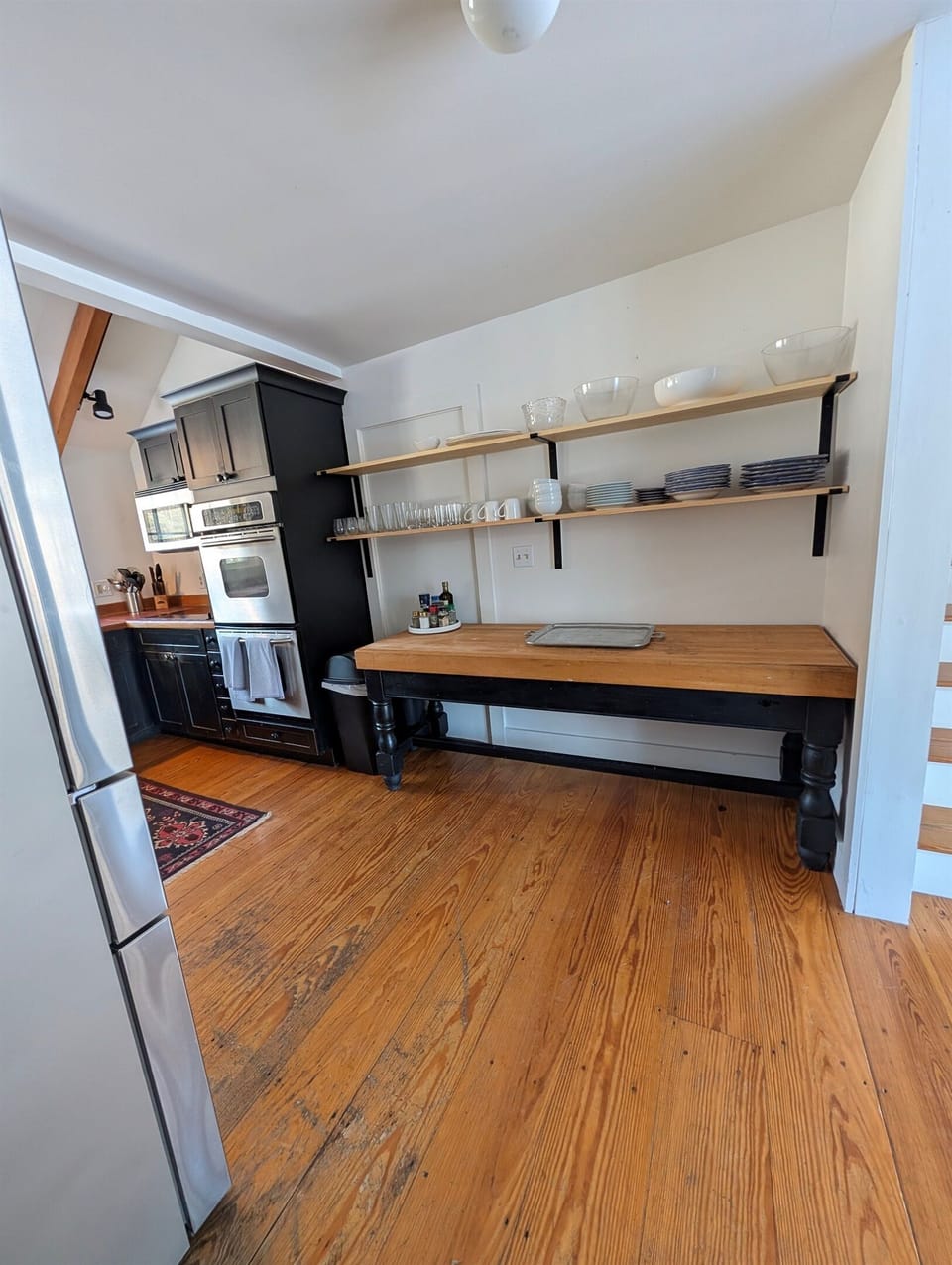 Generous counter space and open shelving make this kitchen area perfect for cooking, serving, and gathering.