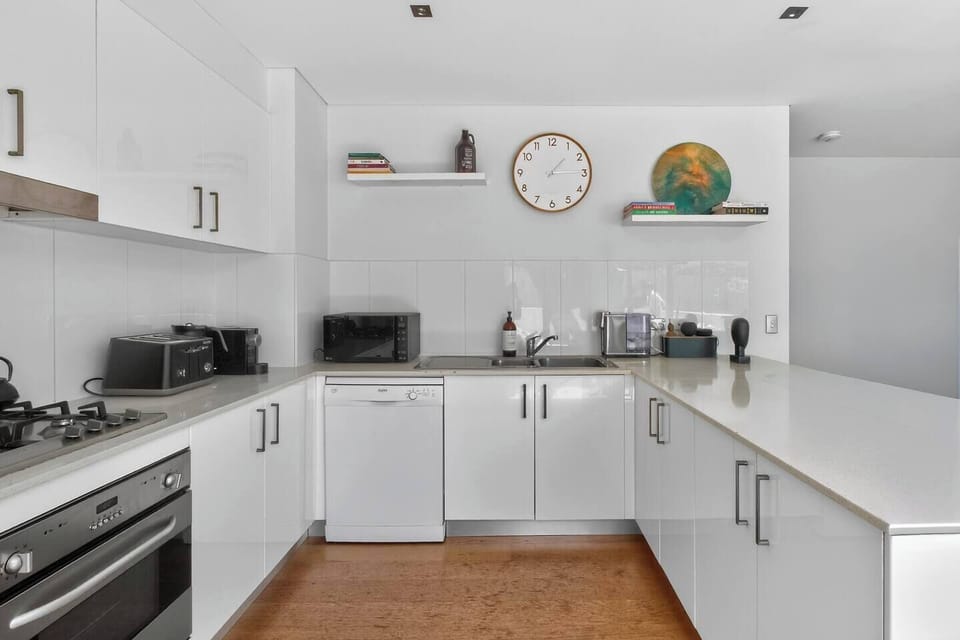 The kitchen provides a practical, modern space to prepare meals with an oven, fridge, dishwasher, microwave and cooking basics supporting comfortable everyday living.